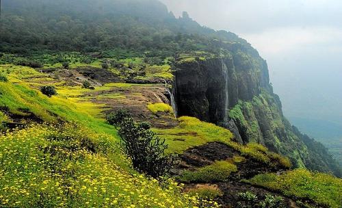 Monsoon trek to Naneghat in Maharashtra with lush green hills, mist-covered trails, and adventurous hikers exploring the scenic Western Ghats.
