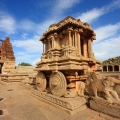 Historic ruins of Hampi in Karnataka, showcasing UNESCO World Heritage stone temples, carved architecture, and rocky landscapes under a clear sky.