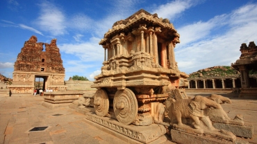 Historic ruins of Hampi in Karnataka, showcasing UNESCO World Heritage stone temples, carved architecture, and rocky landscapes under a clear sky.