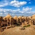 Bada Bagh cenotaphs in Jaisalmer, Rajasthan, featuring historic sandstone monuments in a desert setting during sunset.