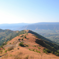 Trek path on Raireshwar Pathar plateau with scenic mountain views and clear skies in Maharashtra.