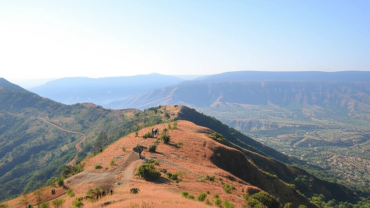 Trek path on Raireshwar Pathar plateau with scenic mountain views and clear skies in Maharashtra.