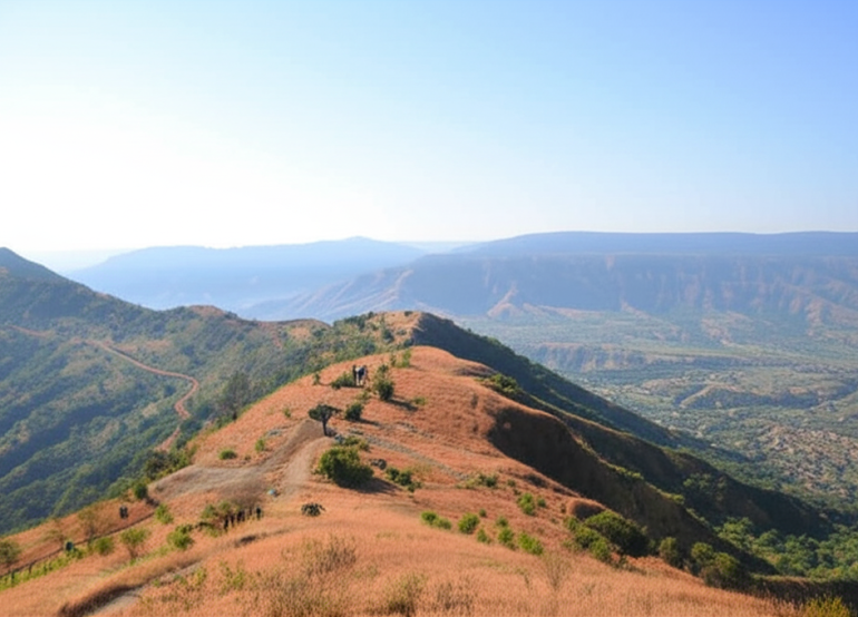 Trek path on Raireshwar Pathar plateau with scenic mountain views and clear skies in Maharashtra.
