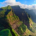 A breathtaking aerial view of Ratangad Fort covered in lush greenery, surrounded by the Sahyadri mountain range in Maharashtra.
