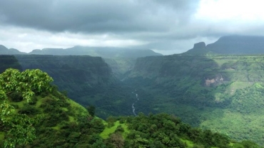 Monsoon view from Sudhagad Fort with lush green valleys and cloudy sky in Raigad, Maharashtra